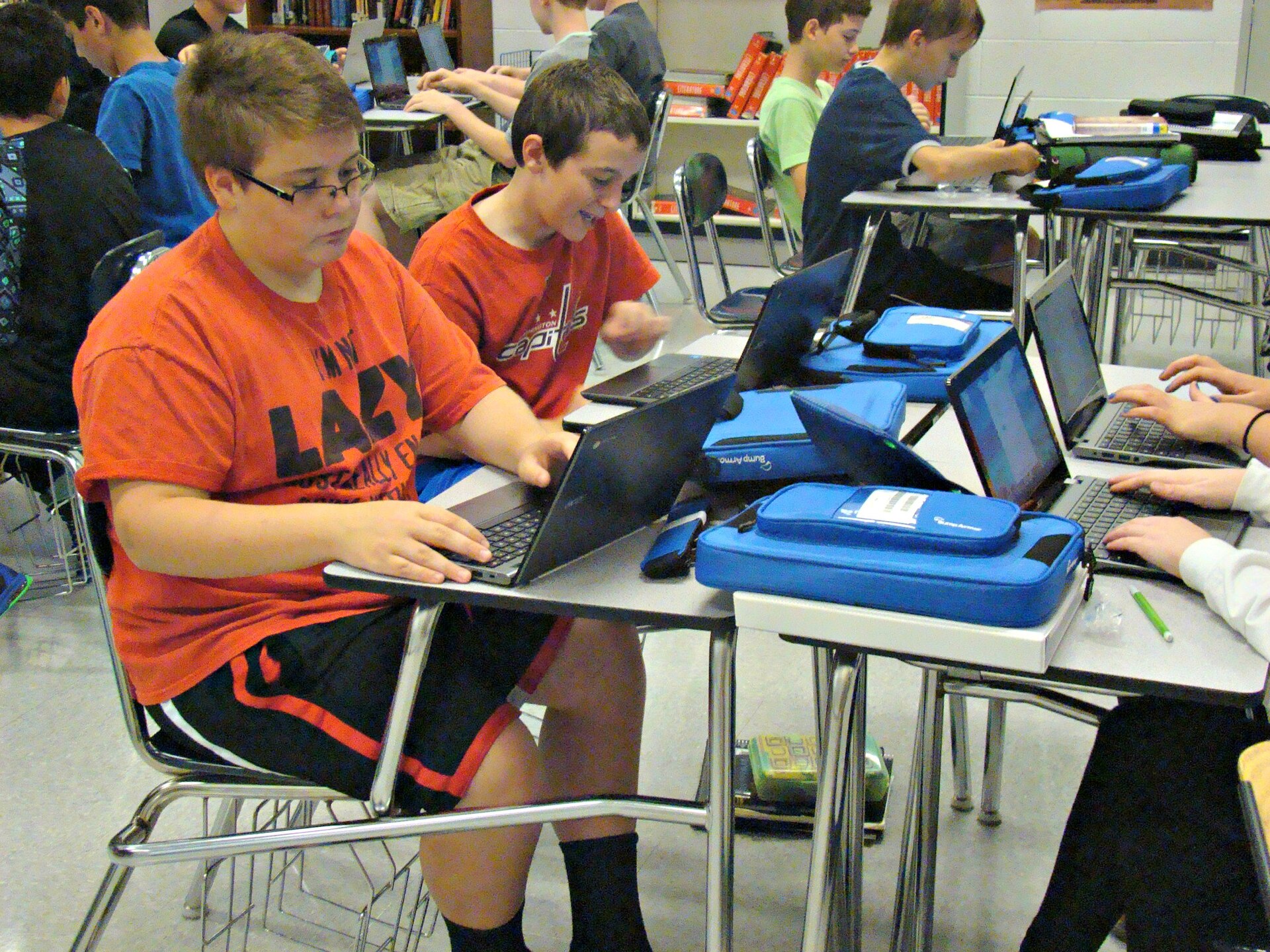 Students working on laptops in a classroom